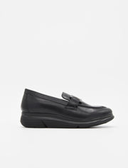 Mocasín de piel negra para mujer, con suela cómoda y adorno metálico en el empeine.