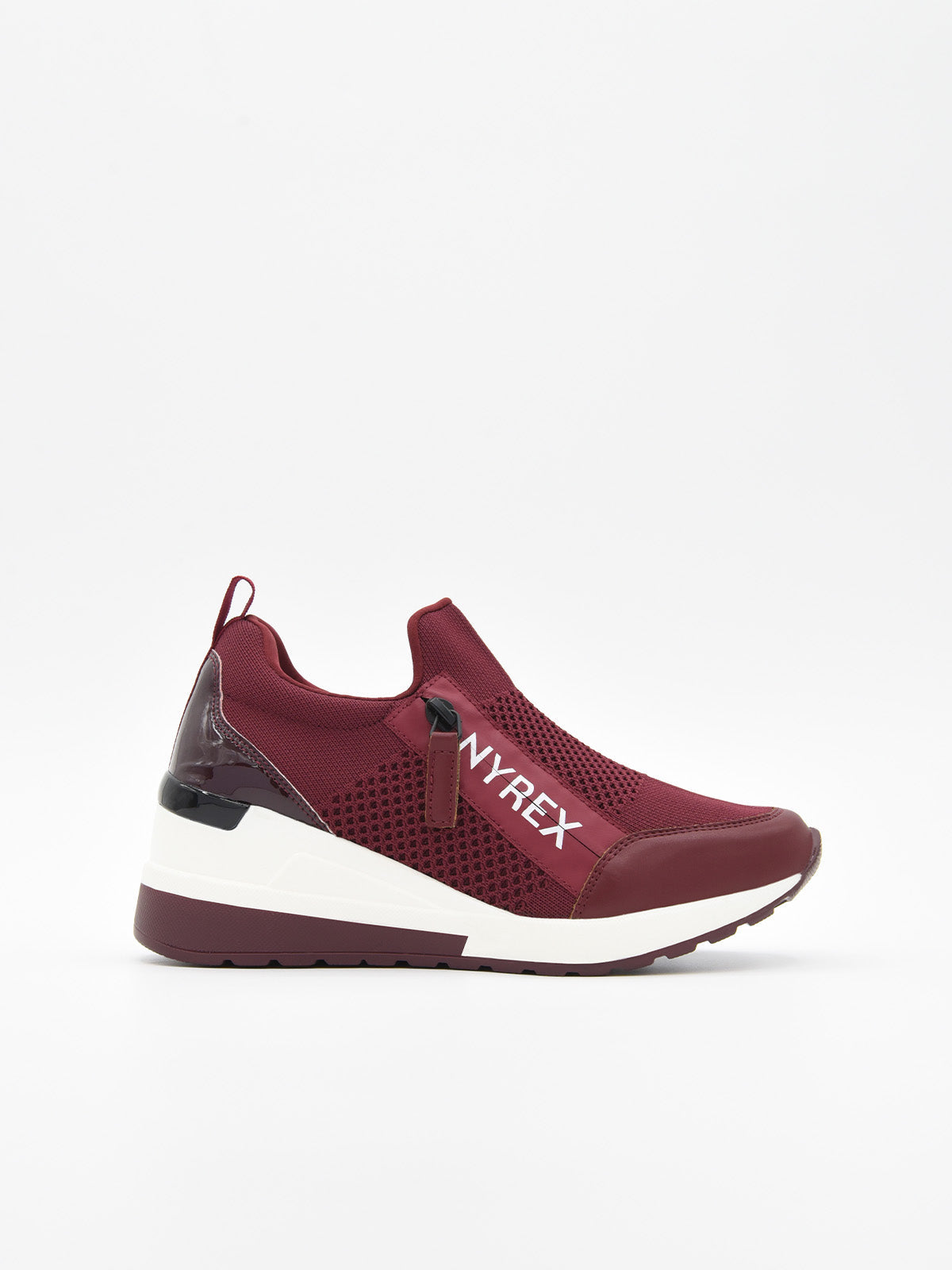 Zapatillas slip-on burdeos de tejido transpirable con cuña interna blanca, suela bicolor y refuerzo brillante en el talón.